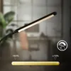 A close-up of a dimmable LED desk lamp with a slider indicating brightness levels. Anteprima dell’immagine prodotto