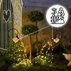 Garden scene at night with solar-powered watering can lights. Anteprima dell’immagine prodotto
