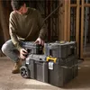 A man is interacting with a stack of toolboxes in what appears to be a construction or workshop environment. Anteprima dell’immagine prodotto