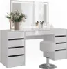 A white vanity table with a mirror and a stool, decorated with flowers and makeup accessories. Náhled obrázku produktu