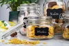 Several glass jars filled with food items, such as cereal and cookies, are arranged on a countertop. Produktbild-Vorschau