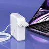 A white laptop charger and USB-C cable are placed next to an open laptop, suggesting they are accessories for the laptop. Podgląd zdjęcia produktu