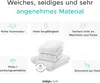 A stack of white towels with descriptive text boxes pointing to their features. Produktbild-Vorschau