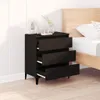 A black dresser with three drawers is placed next to a bed in a bedroom. Anteprima dell’immagine prodotto