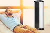A man relaxing on a couch next to a heater. Produktbild-Vorschau