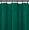 A close-up view of dark green curtains hanging from a black rod. Podgląd zdjęcia produktu