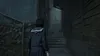 A young woman in a school uniform walks up a dark, narrow alleyway with stairs. Produktbild-Vorschau