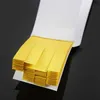A stack of yellow test strips in a white dispenser, against a dark background. Produktbild-Vorschau