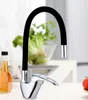 A kitchen faucet with a black flexible neck is shown in a kitchen setting. Produktbild-Vorschau