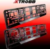 Two black license plate frames are shown against a red and black gradient background. The brand logo 'XTROBB' is visible at the top of the image. Podgląd zdjęcia produktu