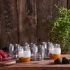 A set of glass jars filled with dessert on a wooden surface. Náhled obrázku produktu