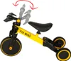 A yellow and black children's tricycle is shown against a white background. Podgląd zdjęcia produktu