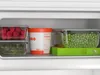 A close-up view of a refrigerator shelf filled with food items. Produktbild-Vorschau