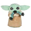 A plush toy of Baby Yoda from The Mandalorian, holding a striped scarf. Produktbild-Vorschau