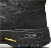 A close-up view of the side of a black Skechers boot, highlighting the sole and branding. Voir les images du produit