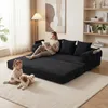 A woman reads a book on a black sectional sofa while a young girl and a dog play on the floor in front of it. The scene is set in a living room with a lamp and artwork on the wall. Produktbild-Vorschau