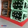 Stacks of plastic crates filled with green glass bottles, resting on red plastic bases. Produktbild-Vorschau