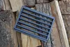 A cast iron grate is placed on a pile of chopped wood. Náhled obrázku produktu