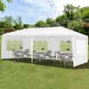 A white party tent set up on a grassy lawn with tables and chairs inside. Podgląd zdjęcia produktu