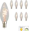 A collection of eight clear, candle-shaped LED light bulbs with a spiral filament, arranged in two rows on a white background. One bulb is prominently displayed in the foreground on the left. Produktbild-Vorschau