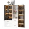 A modern white and black display cabinet with glass doors and LED lighting, filled with books and decorative items. Voir les images du produit