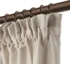 A close-up view of beige outdoor curtains hanging from a bronze curtain rod. Produktbild-Vorschau