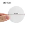 A hand is holding a round coffee filter paper, with a measurement indicating its diameter. Produktbild-Vorschau