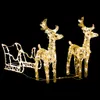 A lighted Christmas decoration of a sleigh and two reindeer on a black background. Podgląd zdjęcia produktu