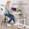 A woman is working on a laptop at a mobile desk in a room. Anteprima dell’immagine prodotto