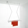 A white ceiling-mounted clothes drying rack with orange towels hanging from it, set against a plain white background. Podgląd zdjęcia produktu