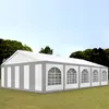 A large white and gray party tent is set up on a grassy lawn with trees and a blue sky in the background. Produktbild-Vorschau