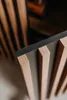 A close-up view of a wooden sideboard with a dark gray accent. Produktbild-Vorschau