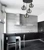 A modern kitchen with a dining area, featuring a pendant light fixture over a table and chairs. Produktbild-Vorschau