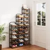 A collection of tiered shoe racks filled with shoes, positioned in a hallway next to a door. Produktbild-Vorschau