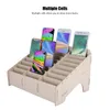 A wooden organizer with multiple compartments holding several smartphones. Anteprima dell’immagine prodotto
