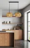 A kitchen scene with two pendant lights hanging over a wooden island and cabinets. Produktbild-Vorschau