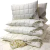 A stack of white pillows on a white surface. Produktbild-Vorschau