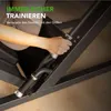 A person's hand is shown operating a lever on a leg press machine. Produktbild-Vorschau