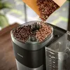Coffee beans being poured into a Philips coffee maker with an integrated grinder. Produktbild-Vorschau