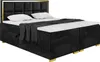 A black upholstered boxspring bed with a gold frame and headboard, shown with white pillows and a grey throw blanket. Produktbild-Vorschau