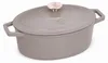 A taupe oval cast iron Dutch oven with a rose gold knob on the lid, shown from a diagonal angle against a white background. Náhľad obrázku produktu