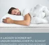 A man sleeping on a bed with a white duvet. Produktbild-Vorschau