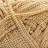 A close-up, detailed view of a ball of gold-colored yarn. Podgląd zdjęcia produktu