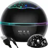 A black star projector lamp with a USB cable and a decorative dome. Voir les images du produit