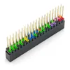A close-up, angled view of a 40-pin GPIO stacking header for a Raspberry Pi, with gold pins and colored plastic insulators, set against a white background. Produktbild-Vorschau