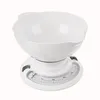 A white mechanical kitchen scale with a bowl on top, set against a white background. Voir les images du produit