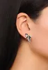 Close-up of a woman's ear wearing a bow-shaped earring. Produktbild-Vorschau