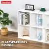 A white cube shelf unit filled with decorative items and books, set against a light gray wall and wooden floor. Náhled obrázku produktu
