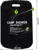 A black camping shower bag with green attachments and a hose, displayed against a white background. Náhled obrázku produktu