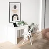 A white folding table and chair set in a room with a framed picture on the wall and a sofa in the background. Produktbild-Vorschau